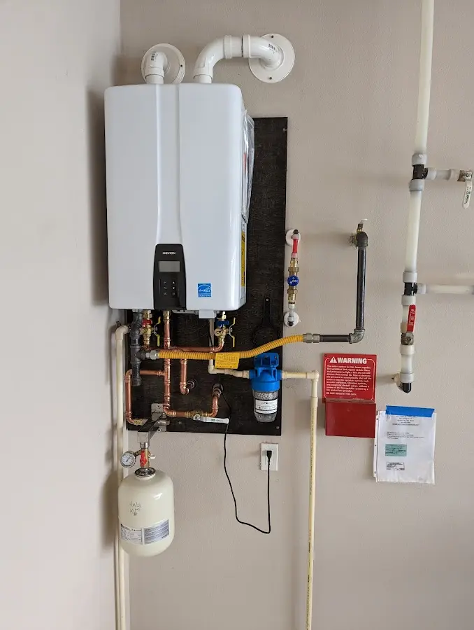 Professional plumber installing copper piping in a Statesville home